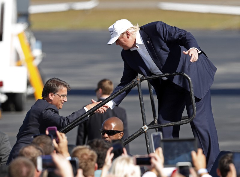 Gov. Pat McCrory campaigning with Donald Trump. CREDIT: AP Photo/John Bazemore