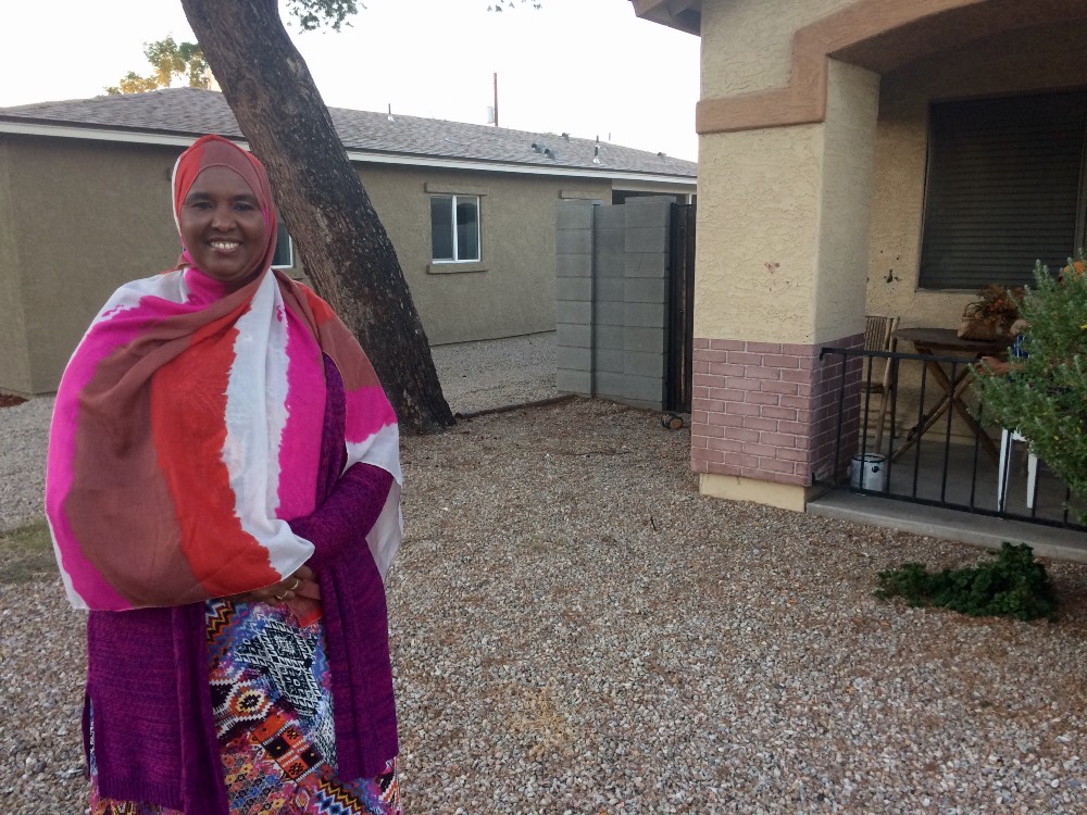 Ibado Mahmud, a Somali refugee who is now a citizen, outside the home she purchased in Phoenix. CREDIT: Alice Ollstein
