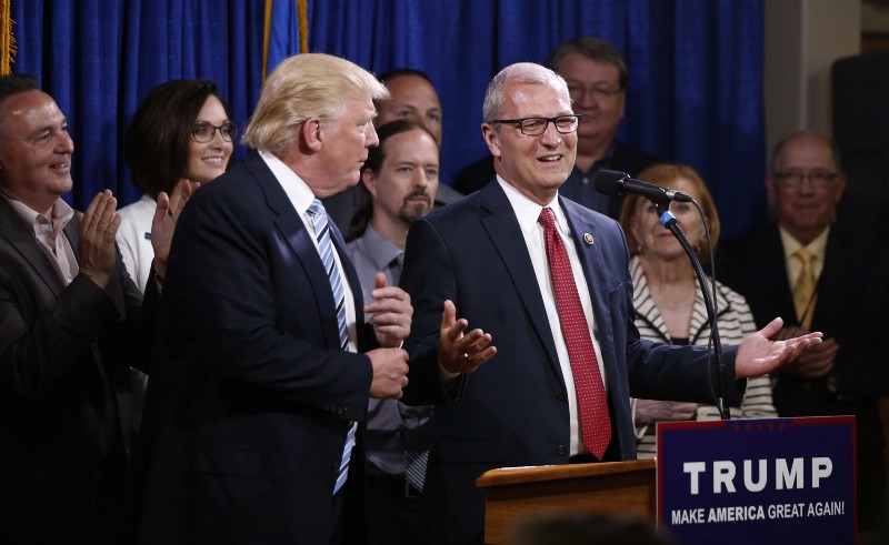 Rep. Kevin Cramer, right, talks about being one of the first to endorse Republican presidential candidate Donald Trump. CREDIT: AP/Charles Rex Arbogast