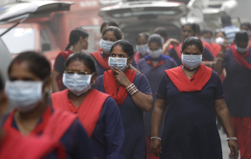 Indian women wear pollution masks at a protest against air pollution in New Delhi CREDIT: AP/Manish Swarup