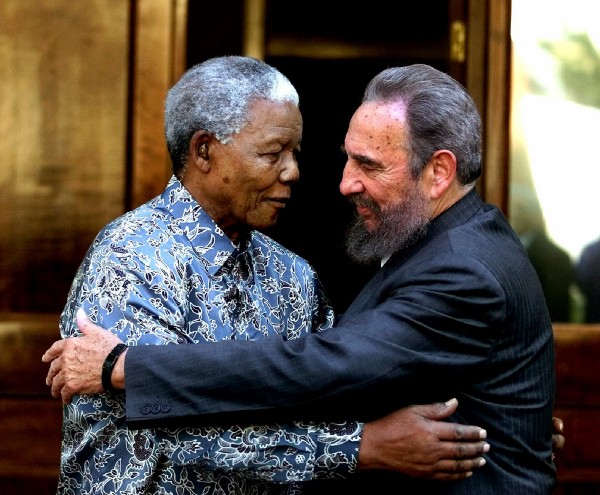 In this Sept. 2, 2001, file photo, former South African President Nelson Mandela, left, and Cuban leader Fidel Castro embrace during a visit by Castro in Johannesburg, South Africa. CREDIT: AP Photo/Jose Goitia