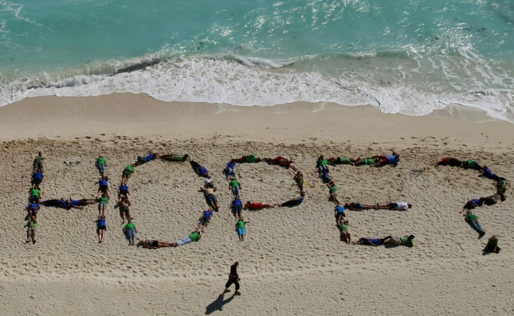 Greenpeace activists form the word hope. CREDIT: AP Photo/Israel Leal