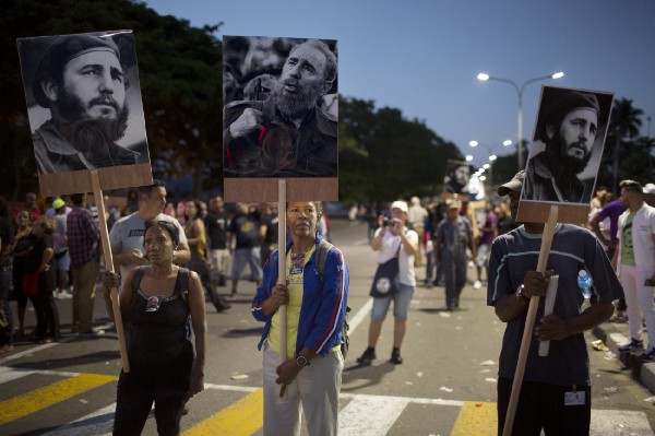 Members of the Cuban community dance in Miami celebrate Castro’s passing, while those in Cuba mourn. CREDIT: AP