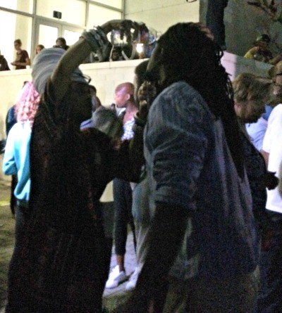 A woman pours water into the eyes of a protester who was maced. CREDIT: Aviva Shen