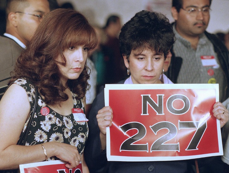 Dolores Sanchez, right, and Tere Rivera watch dejectedly as a television monitor announces the passing of Proposition 227 in a East Los Angeles Mexican restaurant, Tuesday, June 2, 1998. CREDIT:AP/Brian Pobuda