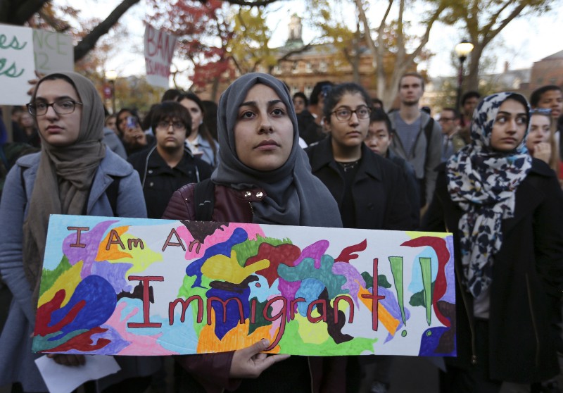 A student holds a sign as she joins a large crowd gathered to protest some of President-elect Donald Trump’s policies. CREDIT: AP Photo/Mel Evans