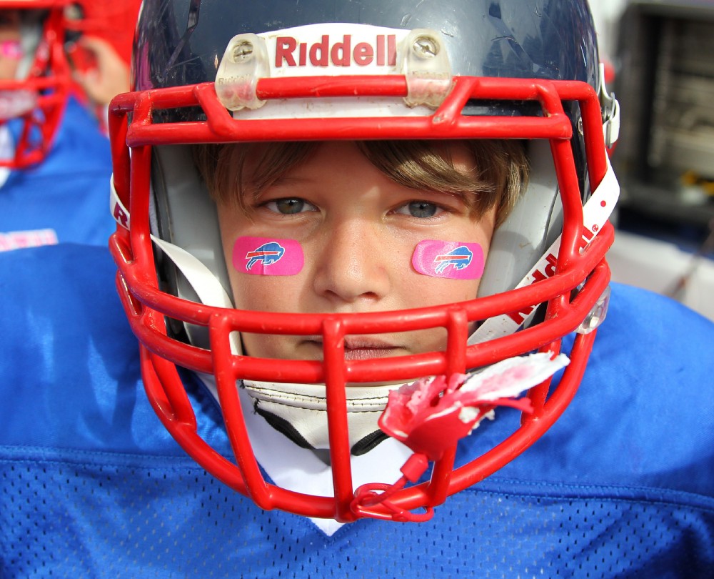 A youth football player from North Tonawanda, N.Y. prepares to take the field at halftime of an NFL football game between the Buffalo Bills and New York Giants, Sunday, Oct. 4, 2015, in Orchard Park, N.Y. CREDIT: AP Photo/Bill Wippert