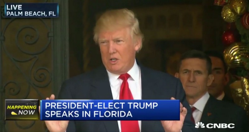 Trump speaks while Lt. Gen. Michael Flynn, his choice for national security adviser, stands behind him. CREDIT: CNBC screengrab