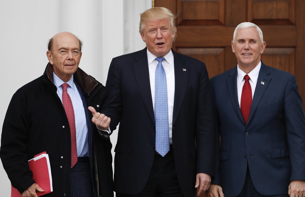 Wilbur Ross, with Donald Trump and Mike Pence, last Sunday CREDIT: AP Photo/Carolyn Kaster