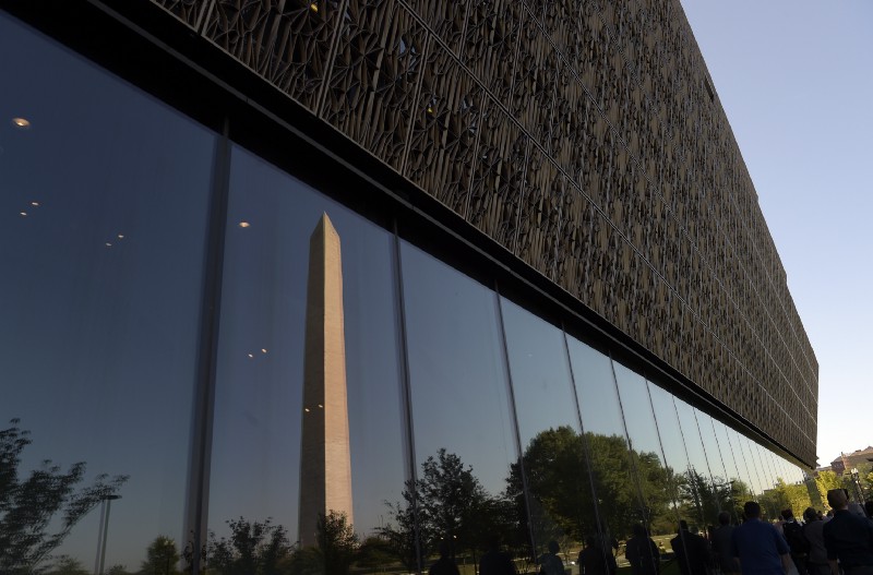 The Washington Monument is reflected in a window of the National Museum of African American History and Culture in Washington, Wednesday, Sept. 14, 2016, during a press preview. CREDIT: AP Photo/Susan Walsh