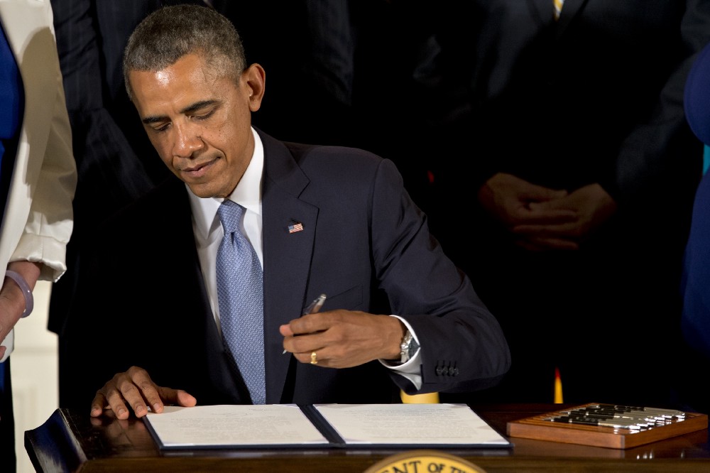 President Obama in 2014 signing an executive order banning anti-LGBT discrimination by federal contractors. CREDIT: AP Photo/Jacquelyn Martin