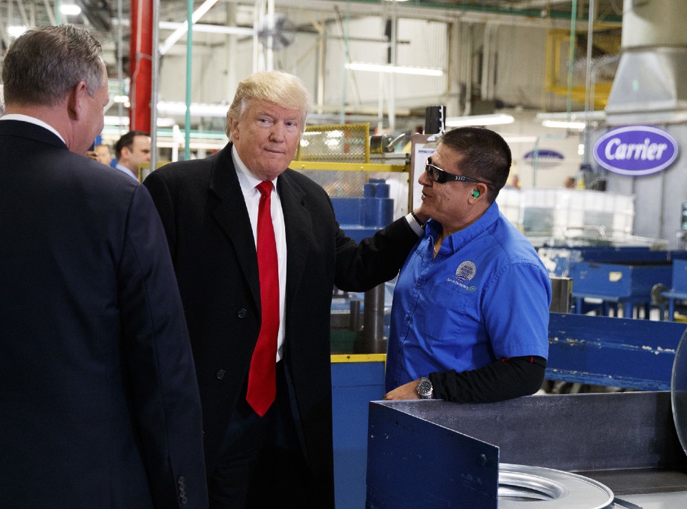 President-elect Donald Trump talks with workers during a visit to the Carrier factory, Thursday, Dec. 1, 2016, in Indianapolis, Ind. CREDIT: AP Photo/Evan Vucci