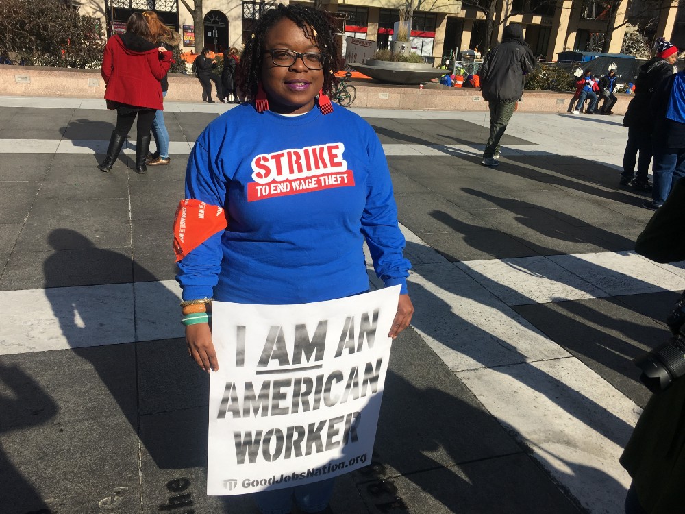 Latoya Williams strikes in downtown Washington, D.C. with hundreds of federal contractors, Wednesday, December 7, 2016. CREDIT: Kira Lerner