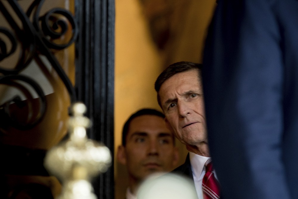 Retired Gen. Michael Flynn, a senior adviser to President-elect Trump, listens as Trump speaks to members of the media at Mar-a-Lago on Wednesday. CREDIT: AP Photo/Andrew Harnik
