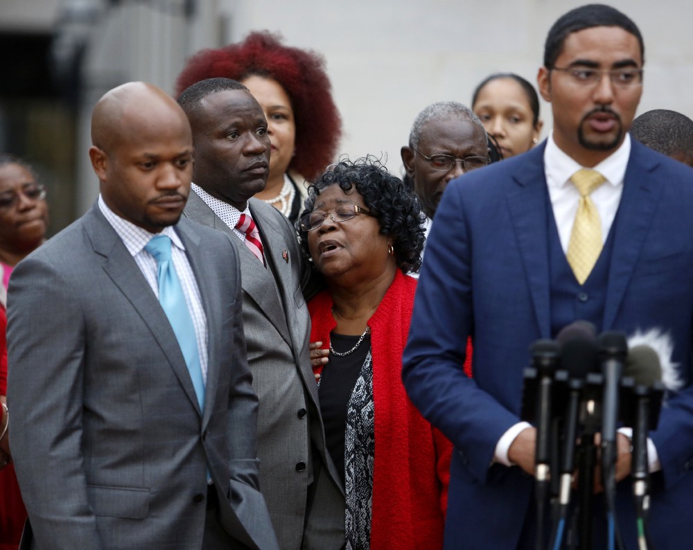 Judy Scott, center, Walter Scott’s mother, is comforted by her son Rodney Scott, as the family attorneys, Chris Stewart, left, and Justin Bamberg, right, hold a press conference after the mistrial was declared for the Michael Slager trial Monday Dec. 5, 2016, in Charleston, S.C. CREDIT: AP Photo/Mic Smith