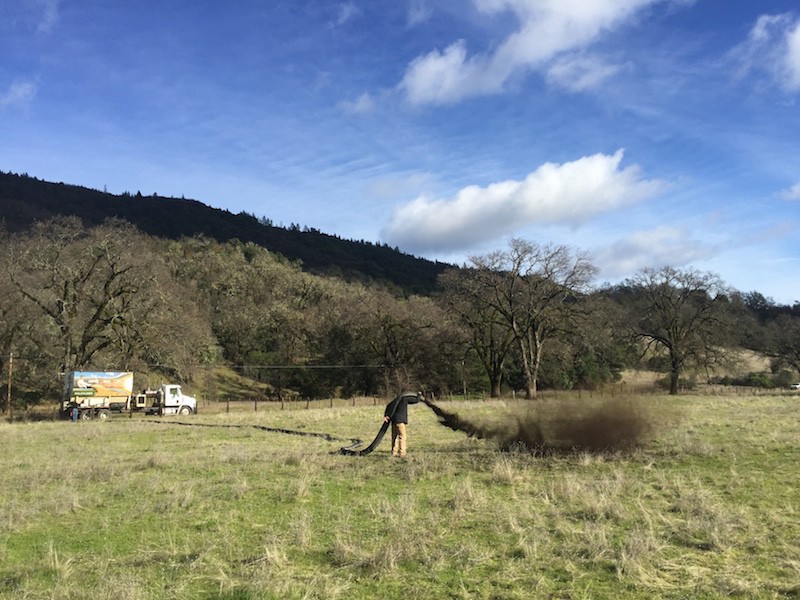 Pouring compost on Romm Ranch in Covelo, Calif. CREDIT: John Wick