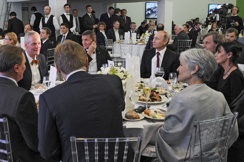 Russian President Vladimir Putin, center right, sits next to Trump’s choice for national security adviser, retired U.S. Lt. Gen. Michael T. Flynn, center left, in Moscow, Russia, on December 10, 2015. CREDIT: Mikhail Klimentyev/AP