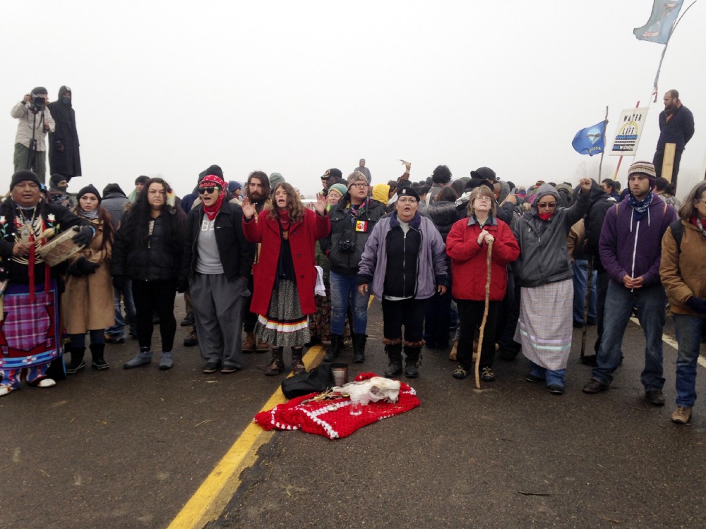 Protesters against the construction of the Dakota Access oil pipeline block a highway in near Cannon Ball, N.D., on Wednesday, Oct. 26, 2016. CREDIT: AP Photo/James MacPherson