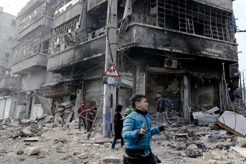 Syrian children remove rubble in the once rebel-held Bustan al-Qasr neighborhood in eastern Aleppo, Syria, Friday, Jan. 20, 2017. CREDIT: AP Photo/Hassan Ammar