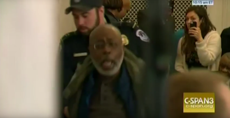 Officers march protesters out of Senate hearing room after they disrupted Sen. Jeff Sessions (R-AL) during his opening remarks. CREDIT: C-SPAN/Screengrab