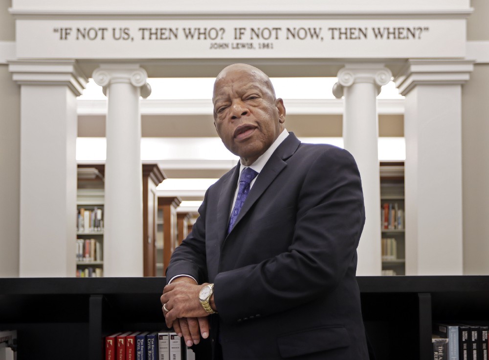 Rep. John Lewis, D-Ga., poses for a photograph under a quote of his that is displayed in the Civil Rights Room in the Nashville Public Library Friday, Nov. 18, 2016, in Nashville, Tenn. CREDIT: AP Photo/Mark Humphrey