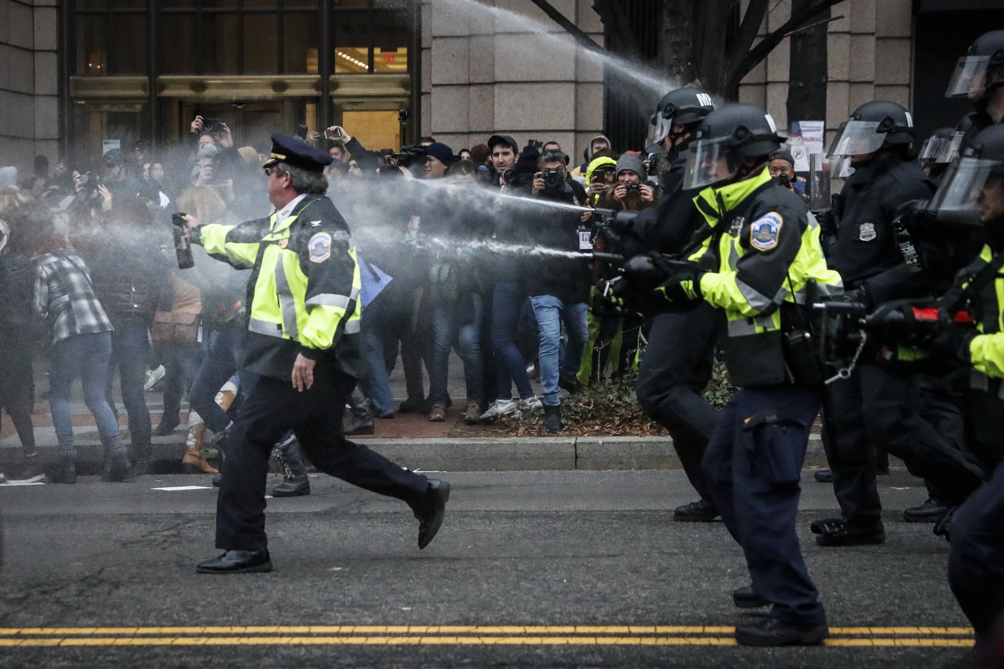 Police deploy pepper spray on Inauguration Day in Washington, D.C., after “kettling” a large crowd. 230 people were eventually arrested and charged with felonies, seemingly without distinguishing between bystanders and those who damaged property. CREDIT: AP Photo/John Minchillo