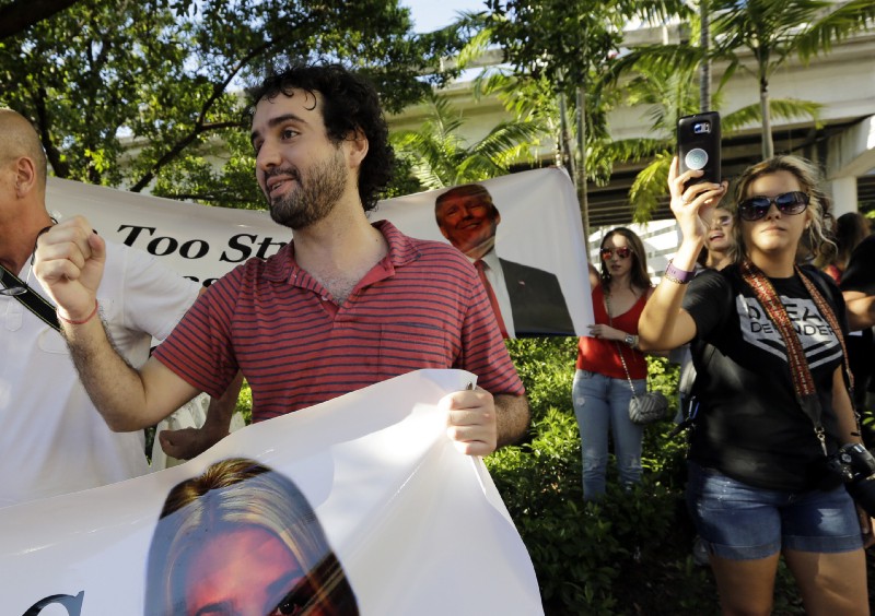 Thomas Kennedy, 25, protests outside of a rally for Donald Trump in Miami. CREDIT: AP Photo/Lynne Sladky