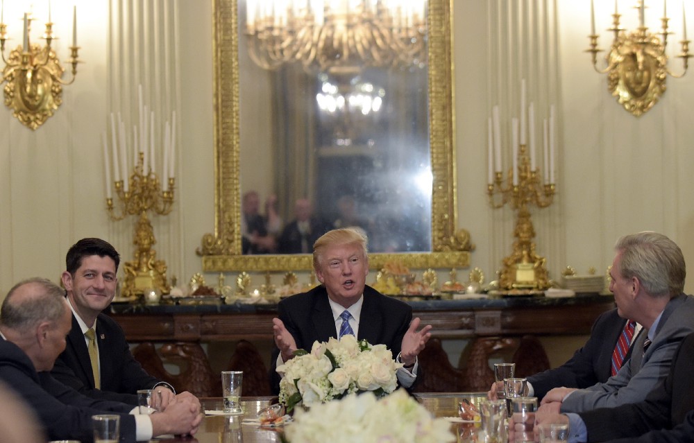President Donald Trump, center, hosts a reception for House and Senate leaders in the the State Dining Room of the White House in Washington, Monday, Jan. 23, 2017. CREDIT: AP Photo/Susan Walsh