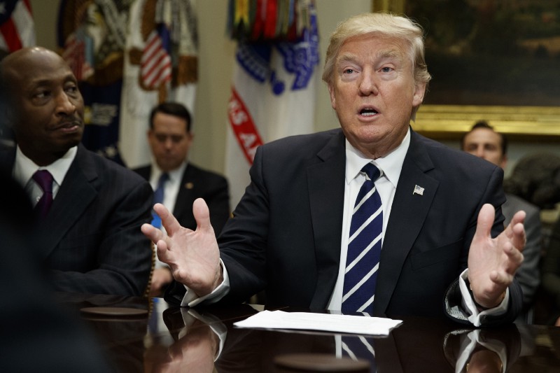 Merck CEO Kenneth Frazier listens at left as President Donald Trump speaks during a meeting with pharmaceutical industry leaders in the Roosevelt Room of the White House in Washington, Tuesday, Jan. 31, 2017. CREDIT: AP Photo/Evan Vucci