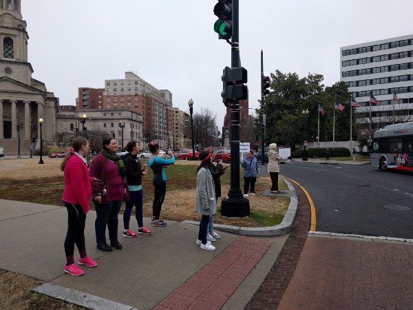 Tina Hobson, 87, solicits cars to honk against Trump as younger protesters pass by Thomas Circle on their way to the march. CREDIT: Alan Pyke/ThinkProgress