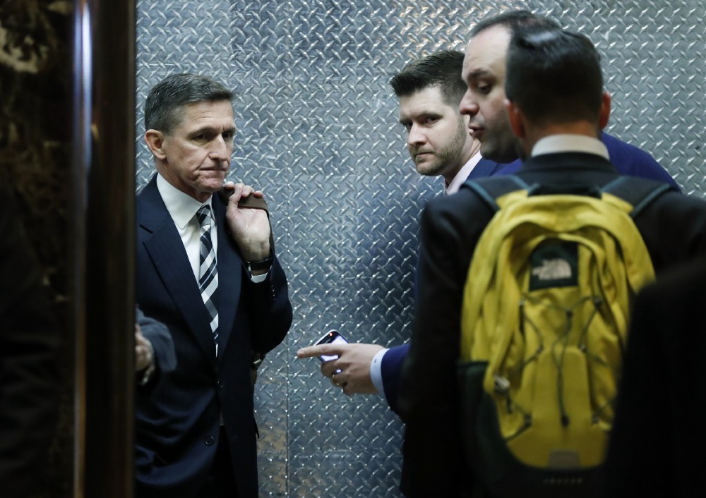 Retired Lt. Gen Michael Flynn, left, his son Michael G. Flynn, second from left, and Boris Epshteyn, a spokesman for President-elect Donald Trump, third from left, board an elevator at Trump Tower in New York on November 17, 2016. CREDIT: AP Photo/Carolyn Kaster, File