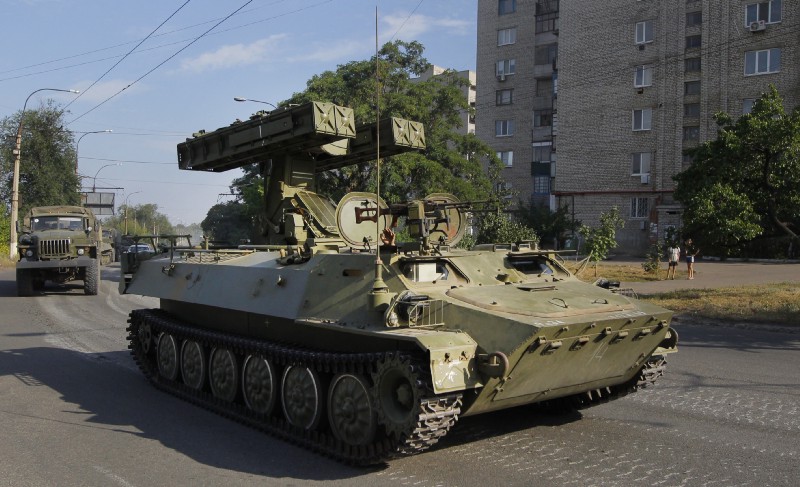 In this is Sunday, Aug. 17, 2014 file photo, a pro-Russian missile launcher drives in the town of Krasnodon. CREDIT: AP Photo/Sergei Grits