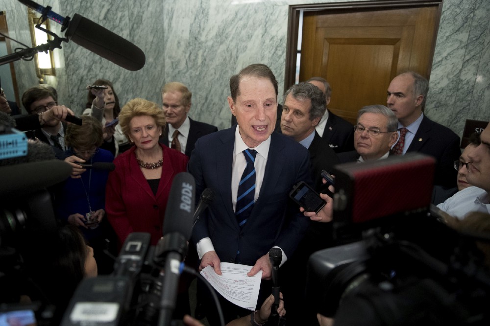 Sen. Ron Wyden, D-Ore., ranking member of the Senate Finance Committee, center, accompanied by, from left, Sen. Debbie Stabenow, D-Mich., Sen. Bill Nelson, D-Fla., Sen. Sherrod Brown, D-Ohio, Sen. Robert Menendez, D-N.Y. and Sen. Bob Casey, D-Pa., speaks in the hallway on Capitol Hill in Washington, Tuesday, Jan. 31, 2017 CREDIT: AP Photo/Andrew Harnik