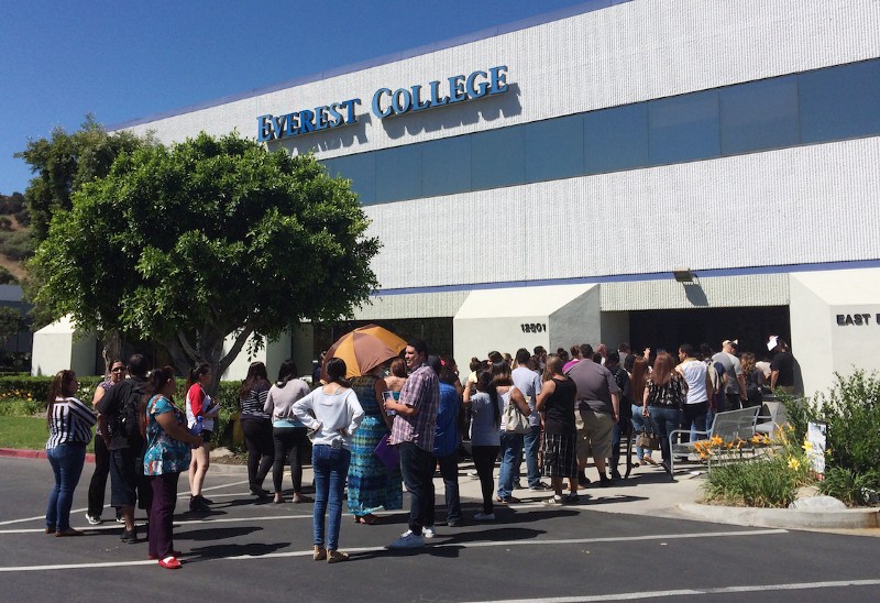In this April 28, 2015 file photo, students wait outside Everest College in Industry, Calif., hoping to get their transcriptions and information on loan forgiveness and transferring credits to other schools. CREDIT: AP/Christine Armario