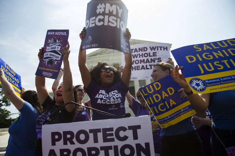 Pro-choice activists celebrate during a rally at the Supreme Court in Washington, June 27, 2016. CREDIT: AP Photo/Evan Vucci