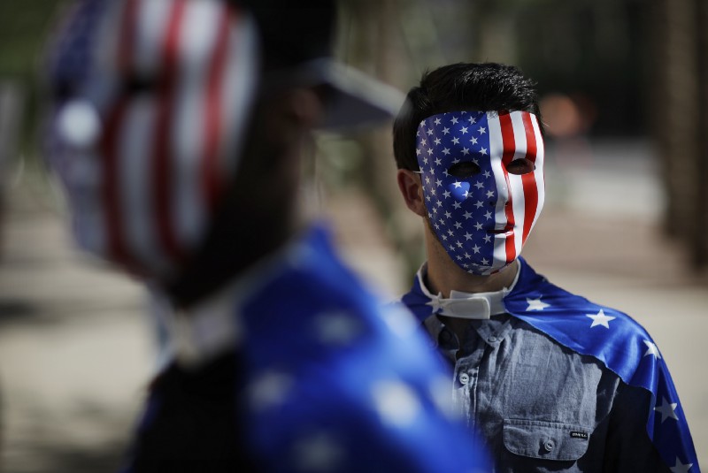 Tyler Einck, right, and Paul Sterkowitz wear masks before entering Trump rally, Oct. 29, 2016, in Phoenix. (CREDIT: AP Photo/John Locher)