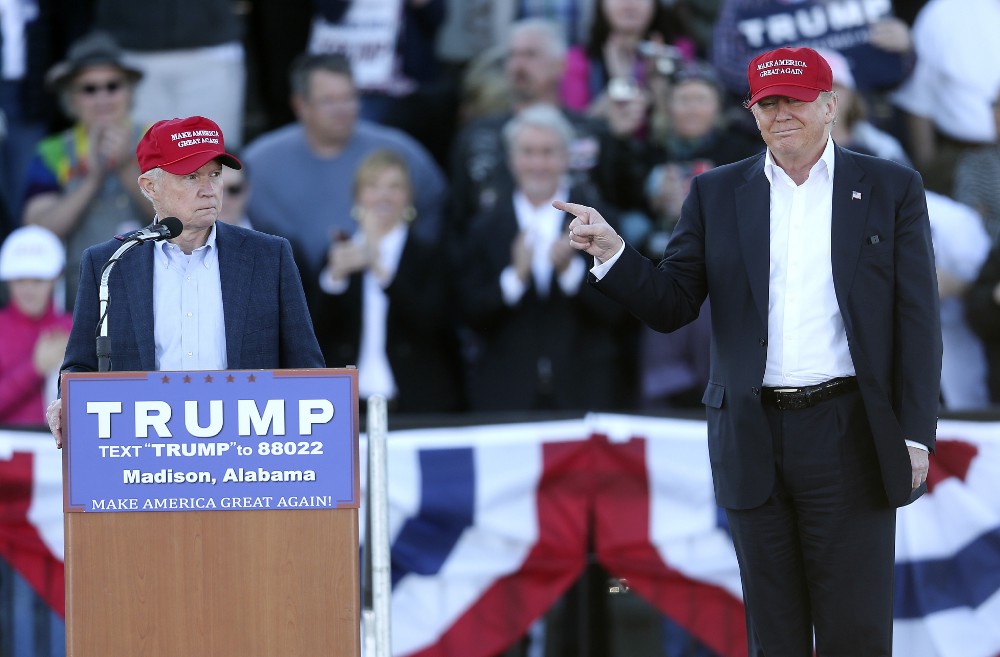 Republican presidential candidate Donald Trump, right, gestures as Sen. Jeff Sessions, R-Ala., speaks during a rally in February 2016. CREDIT: AP Photo/John Bazemore