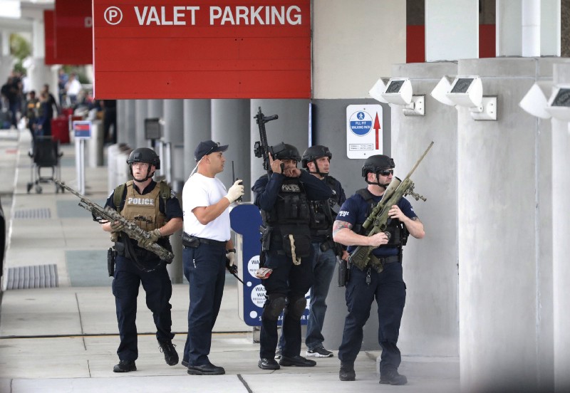 Law enforcement officers at Fort Lauderdale–Hollywood International Airport on Friday. CREDIT: AP Photo/Wilfredo Lee