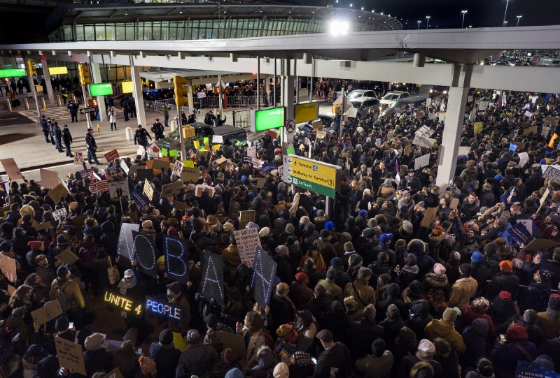 Protesters assemble at John F. Kennedy International Airport in New York, Saturday, Jan. 28, 2017 after earlier in the day two Iraqi refugees were detained while trying to enter the country. On Friday, Jan. 27, President Donald Trump signed an executive order suspending all immigration from countries with terrorism concerns for 90 days. Countries included in the ban are Iraq, Syria, Iran, Sudan, Libya, Somalia and Yemen, which are all Muslim-majority nations. CREDIT: AP Photo/Craig Ruttle