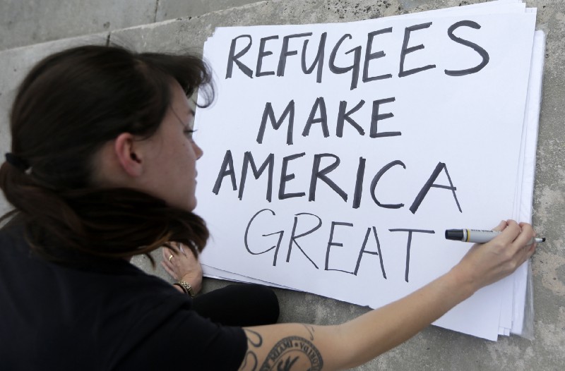 Protester Emily Nostro prepares a sign for a rally against President Donald Trump’s executive order on Muslim immigration in downtown Miami. CREDIT: AP Photo/Alan Diaz