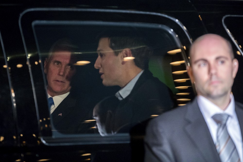 Vice President-elect Mike Pence, left, and Jared Kushner, second from left, speak together in a car as they depart from Trump Tower last month. CREDIT: AP Photo/Andrew Harnik