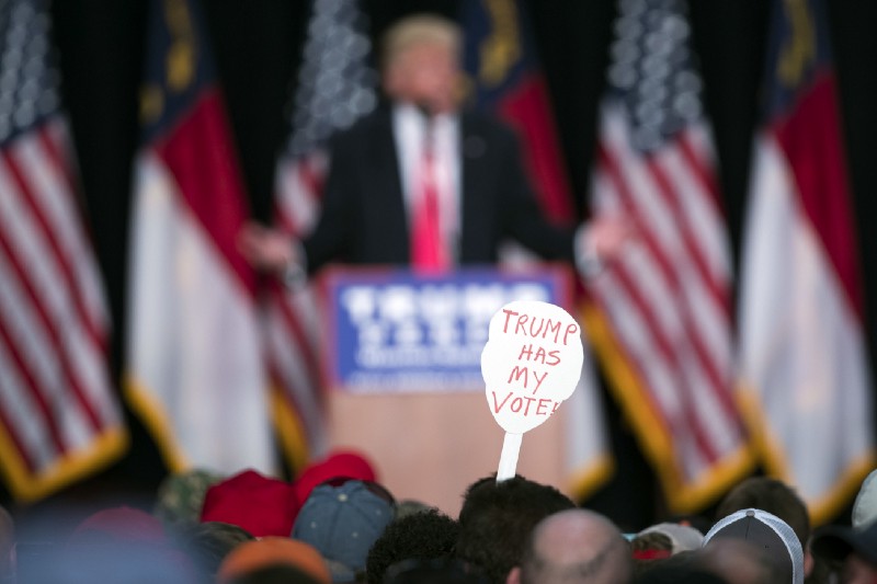 In this Monday, July 25, 2016 file photo, a supporter of Republican presidential candidate Donald Trump holds a sign during a campaign rally in Winston-Salem, N.C. CREDIT: AP Photo/Evan Vucci