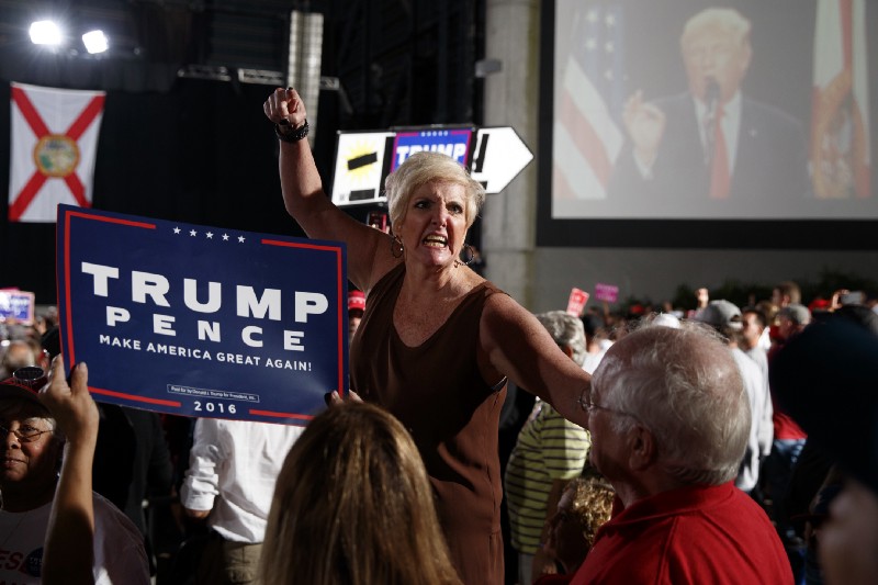 Donna Decker of Sarasota, Fla., screams at reporters during a campaign rally with Republican presidential candidate Donald Trump, Monday, Oct. 24, 2016, in Tampa, Fla. CREDIT: AP Photo/ Evan Vucci