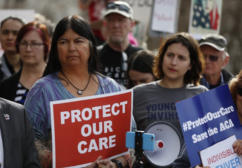 State Sen. Dr. Irene Aguilar, D-Denver, left, stands with activist Christina Postolowski, of the group Young Invincibles, hold a rally on the state Capitol steps in Denver, Tuesday, Jan. 31, 2017. CREDIT: AP Photo/Brennan Linsley