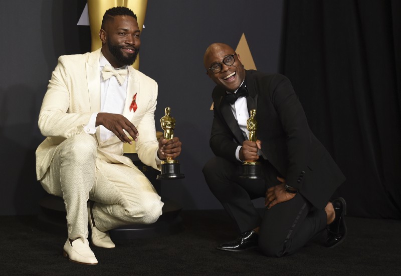 Tarell Alvin McCraney, left, and Barry Jenkins, winners of the award for best adapted screenplay for “Moonlight”, pose in the press room at the Oscars on Sunday, Feb. 26, 2017. CREDIT: Jordan Strauss/Invision/AP