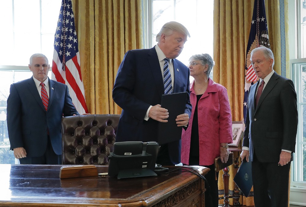 President Donald Trump holding a newly signed executive order at Attorney General Jeff Sessions’ swearing-in ceremony. CREDIT: AP Photo/Pablo Martinez Monsivais