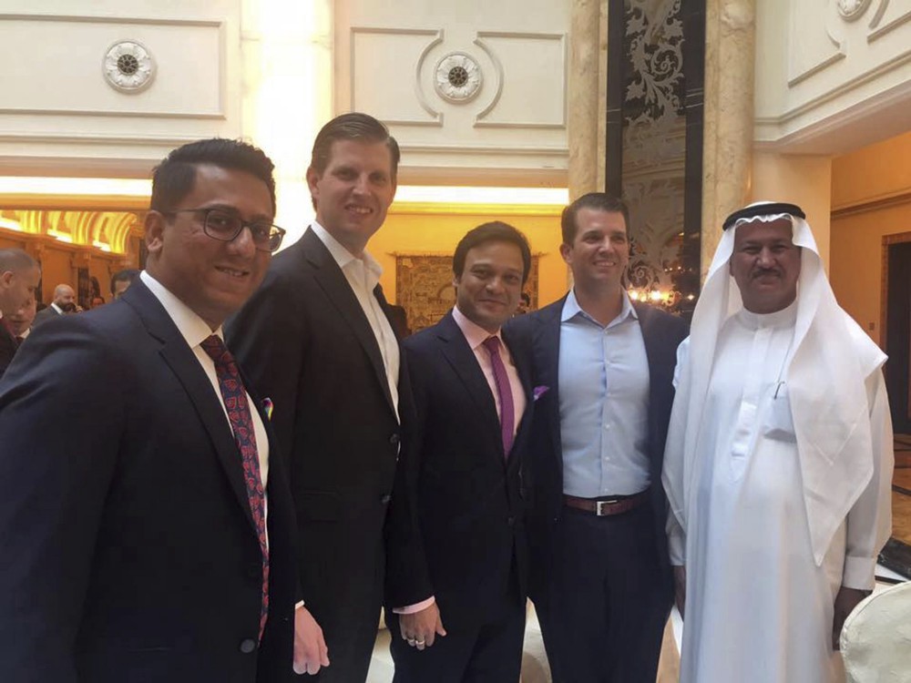 Trump sons Eric and Don Jr. pose for a photo at the formal opening of the Trump International Club in Dubai. CREDIT: AP Photo