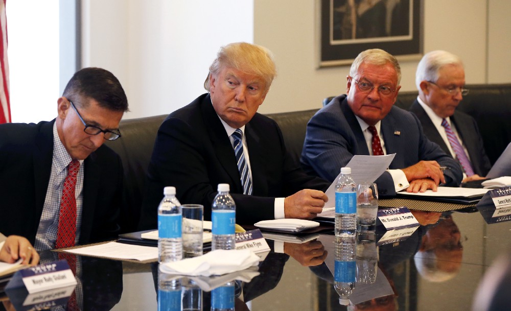 Donald Trump meets with Michael Flyn, left, and Jeff Sessions, right, in August of 2016. CREDIT: AP Photo/Gerald Herbert