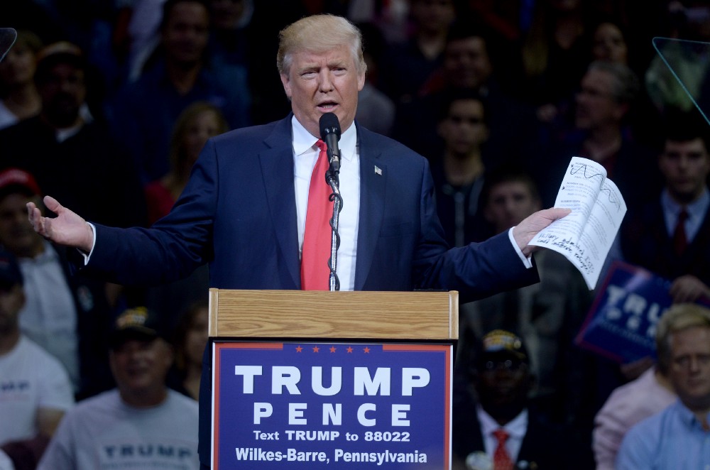 Trump, holding a print out of emails stolen by Wikileaks, expresses his love for leaks during a rally in October. CREDIT: Dennis Van Tine/MediaPunch/IPX