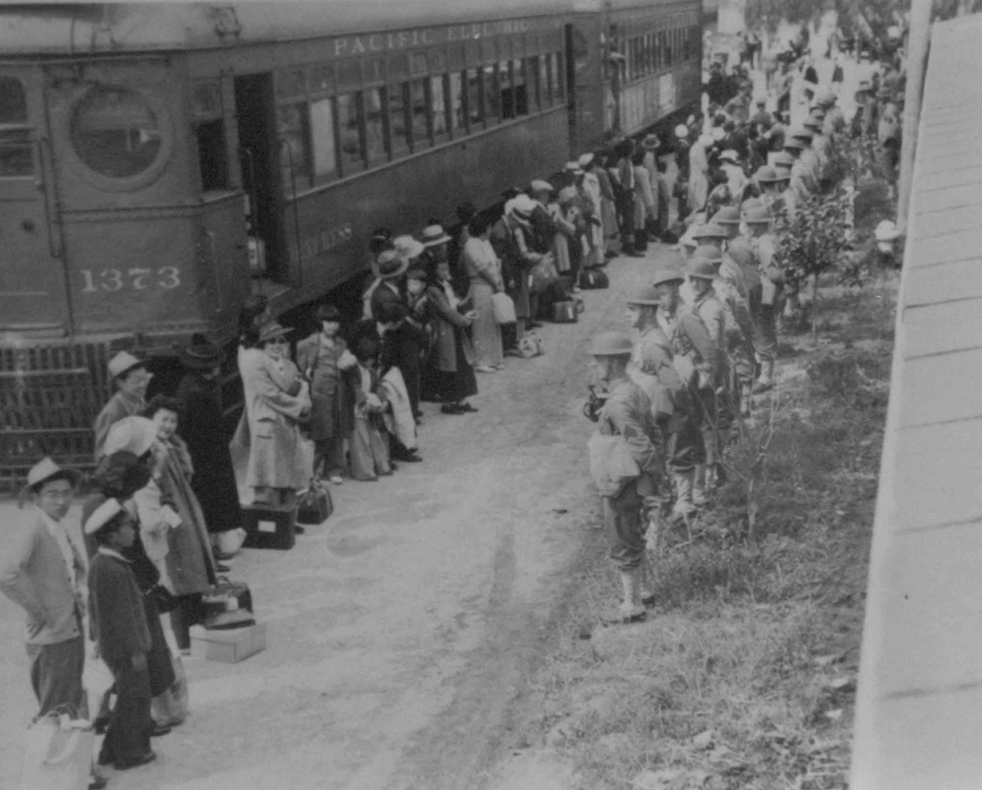 Japanese citizens gather at a train which will take them from the Santa Anita assembly camp in California to the internment camp at Gila River, Ariz. in 1942. CREDIT: AP Photo/National Archives